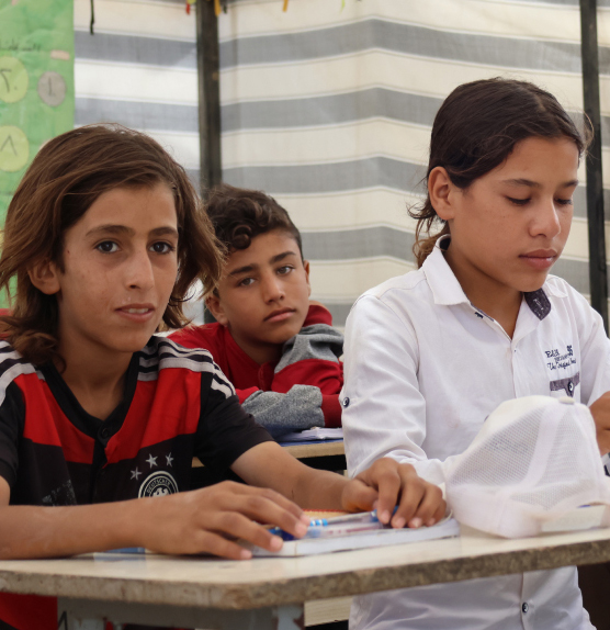 Syrian girl smiling in refugee camp