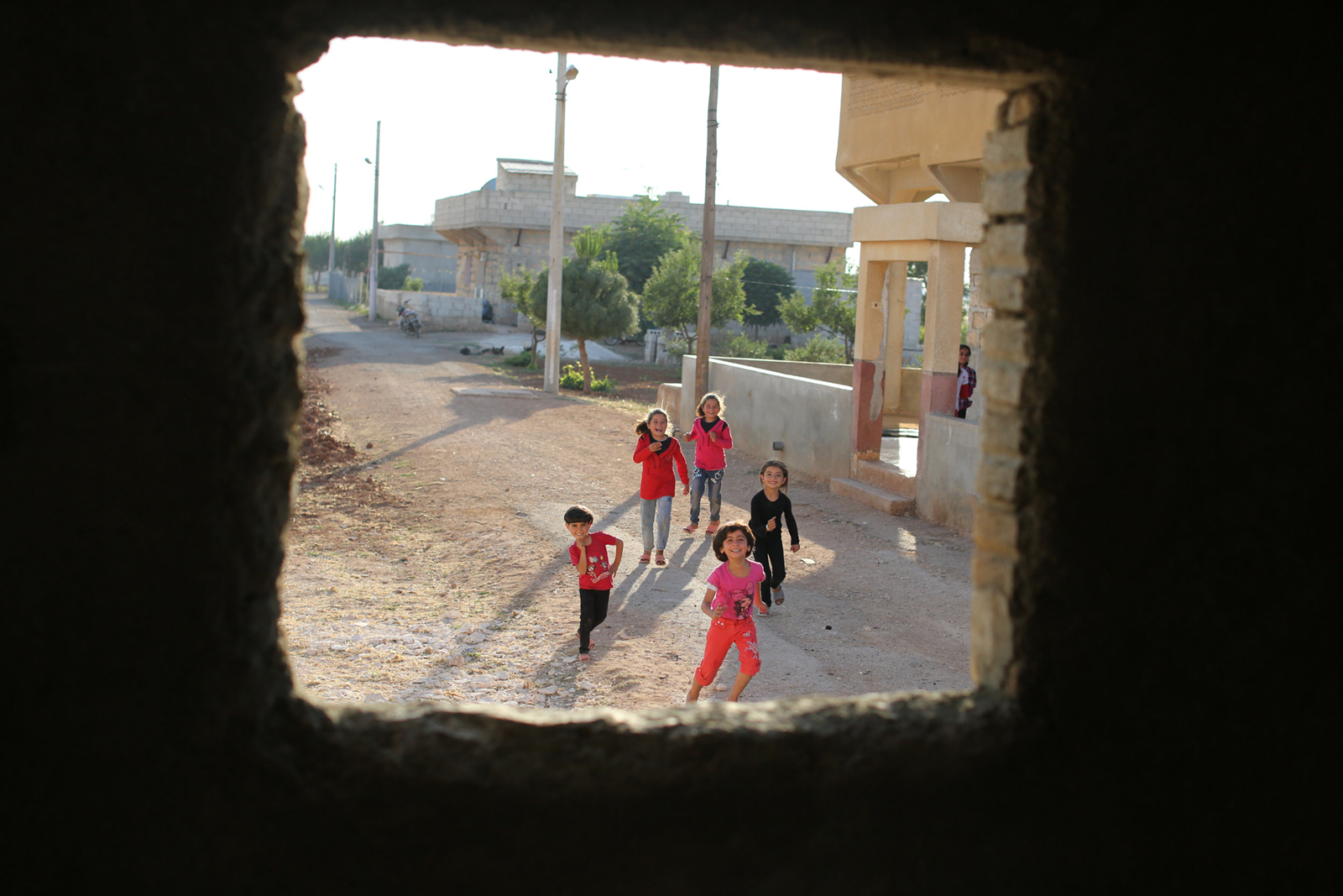 Syrian girls smiling in refugee camp